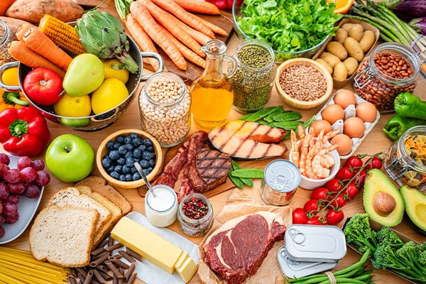 foods that are good for the kidneys. Table filled with large variety of food including carbohydrates, dietary fiber and proteins