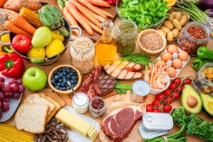 foods that are good for the kidneys. Table filled with large variety of food including carbohydrates, dietary fiber and proteins