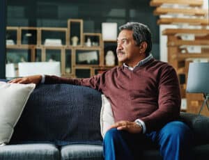Cropped shot of a mature man relaxing on the sofa at home